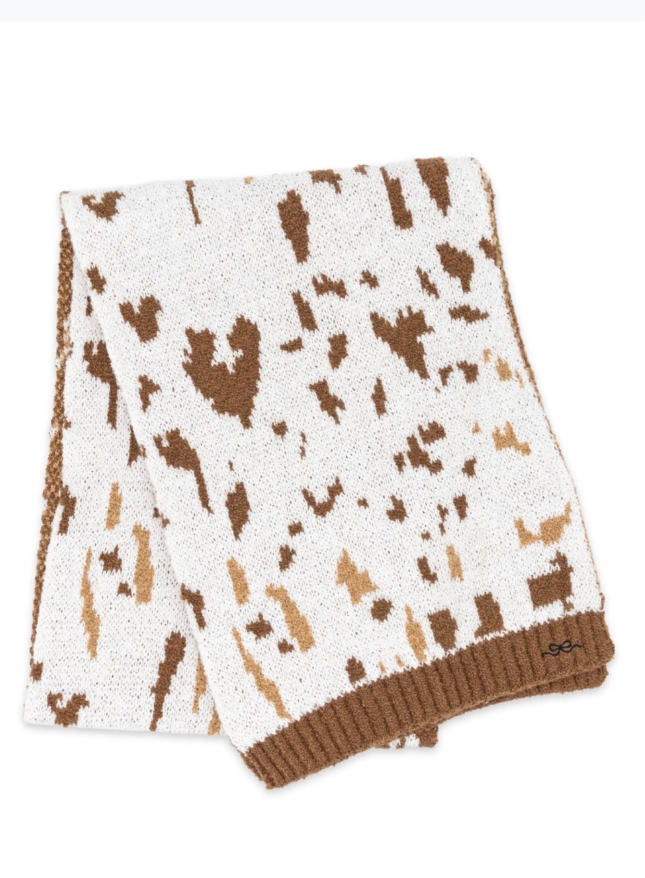 Cow print scarf from Ivy's Gifts & Boutique in lightweight sweater material, featuring a cozy and stylish design.
