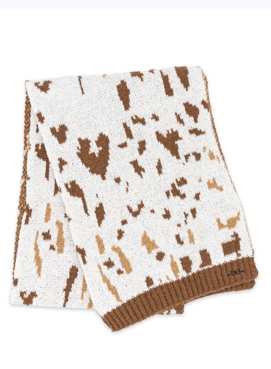 Cow print scarf from Ivy's Gifts & Boutique in lightweight sweater material, featuring a cozy and stylish design.