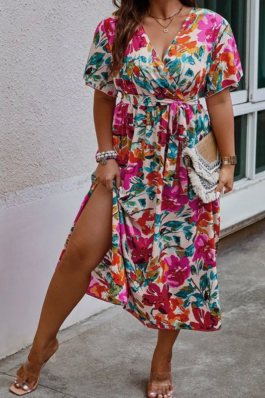 Floral printed dress by Ivy's Gifts & Boutique, showcasing vibrant flowers on a flowing fabric with a flattering silhouette.