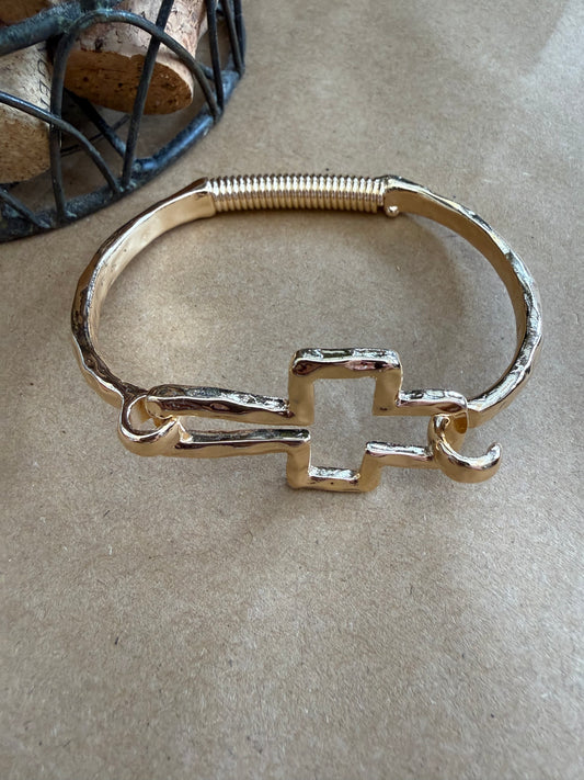 Ivy's Gifts & Boutique J25 Cross Bangle bracelet with flexible spring design, showcasing a sleek, modern jewelry piece for comfortable wear.