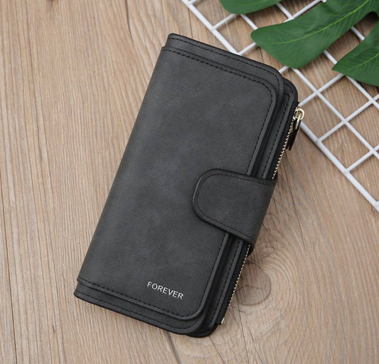 Vegan leather women's wallet with zippered coin pouch and multiple card and ID storage pockets, by Ivy's Gifts & Boutique.