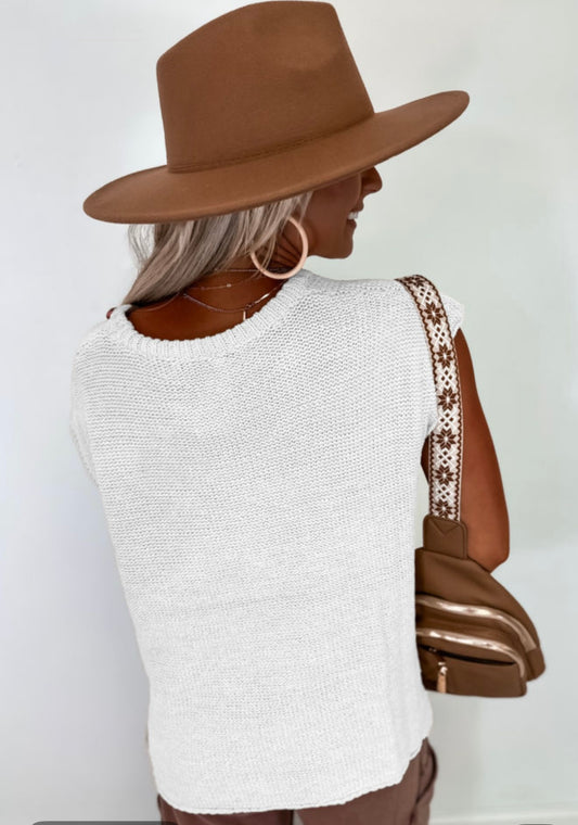 White sleeveless sweater with side splits