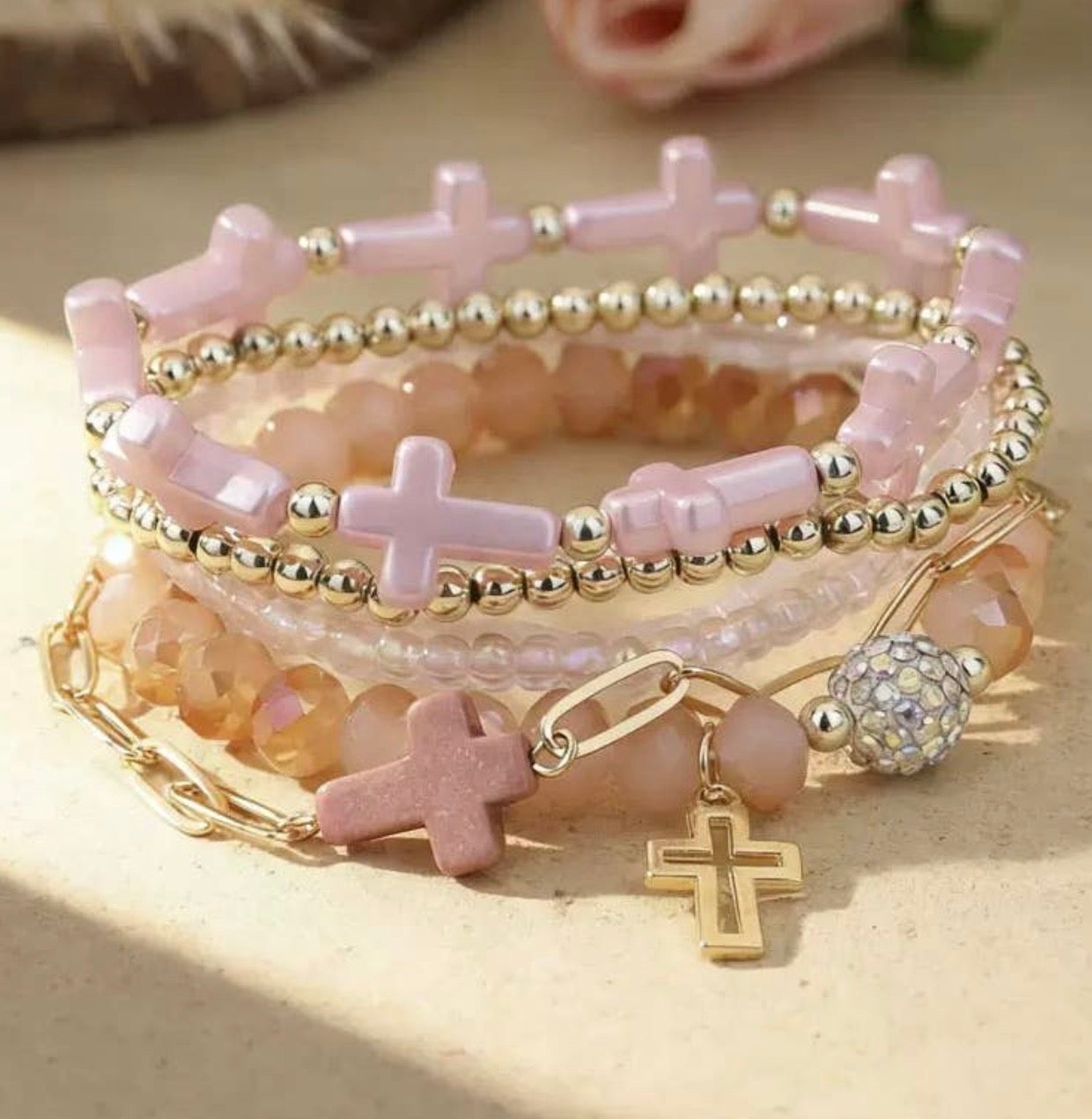 Set of five pink and gold cross stackable bracelets by Ivy's Gifts & Boutique, featuring stylish jewelry with cross charms.