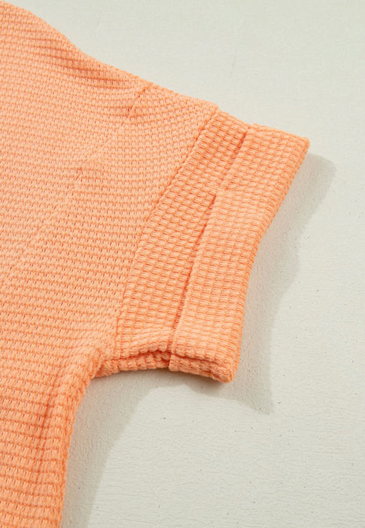 Orange waffle weave short sleeve V-neck top by Ivy's Gifts & Boutique, featuring a comfortable fit and stylish design.
