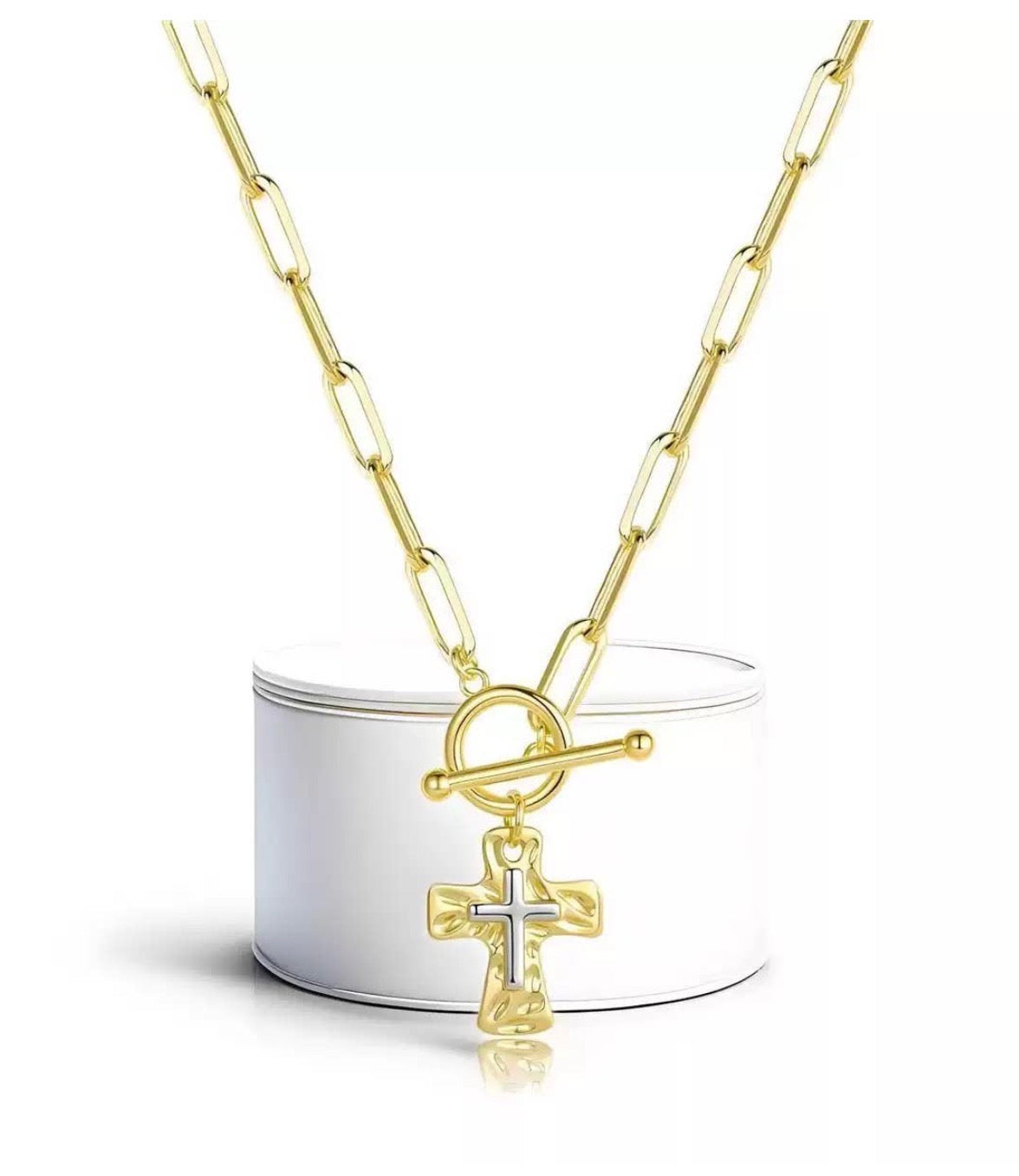 Two-tone metal cross necklace with front closure latch, featuring a sleek design and detailed craftsmanship.