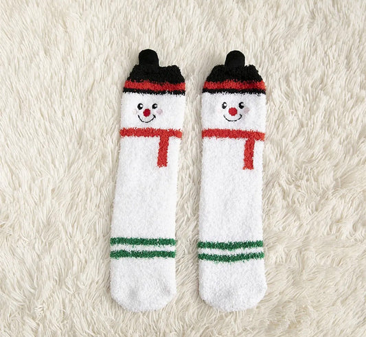 Ivy's Gifts & Boutique holiday socks with pom pom accents, featuring festive patterns and cozy knit fabric.