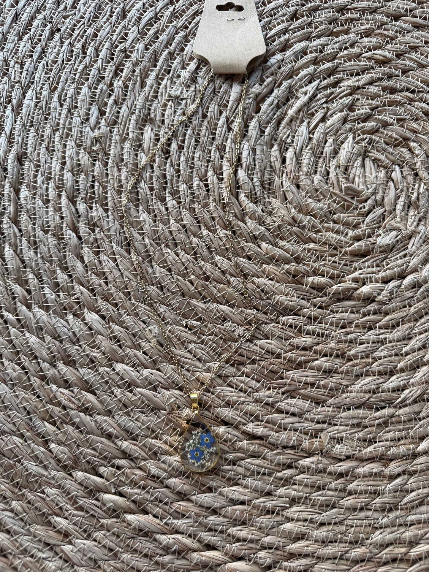 Blue dried flower necklace by Ivy's Gifts, featuring delicate blooms in a stylish pendant design.