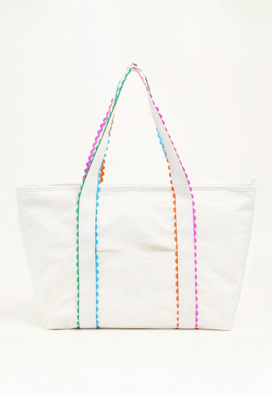 White tote bag with colorful ricrac trim from Ivy's Gifts & Boutique, showcasing a spacious design and vibrant decorative details.