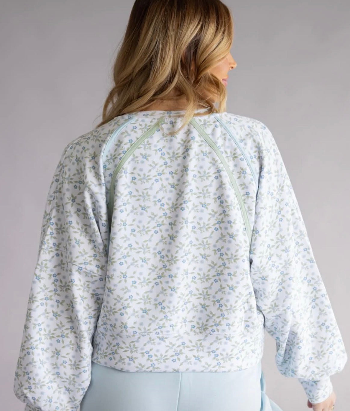 Floral cropped long sleeve top from Ivy's Gifts & Boutique, featuring a vibrant floral pattern and fitted design.