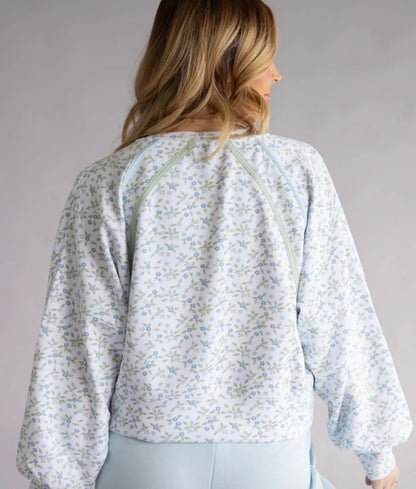 Floral cropped long sleeve top from Ivy's Gifts & Boutique, featuring a vibrant floral pattern and fitted design.