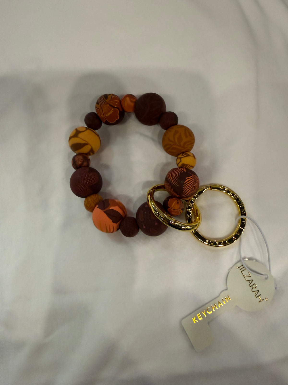Handmade clay bead wrist key ring with colorful beads and adjustable strap, designed by Ivy's Gifts & Boutique.