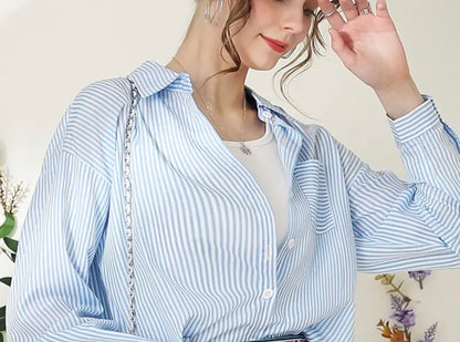 Blue striped button-up blouse by Ivy's Gifts & Boutique, showcasing a versatile, stylish women's top with a classic fit and collar.