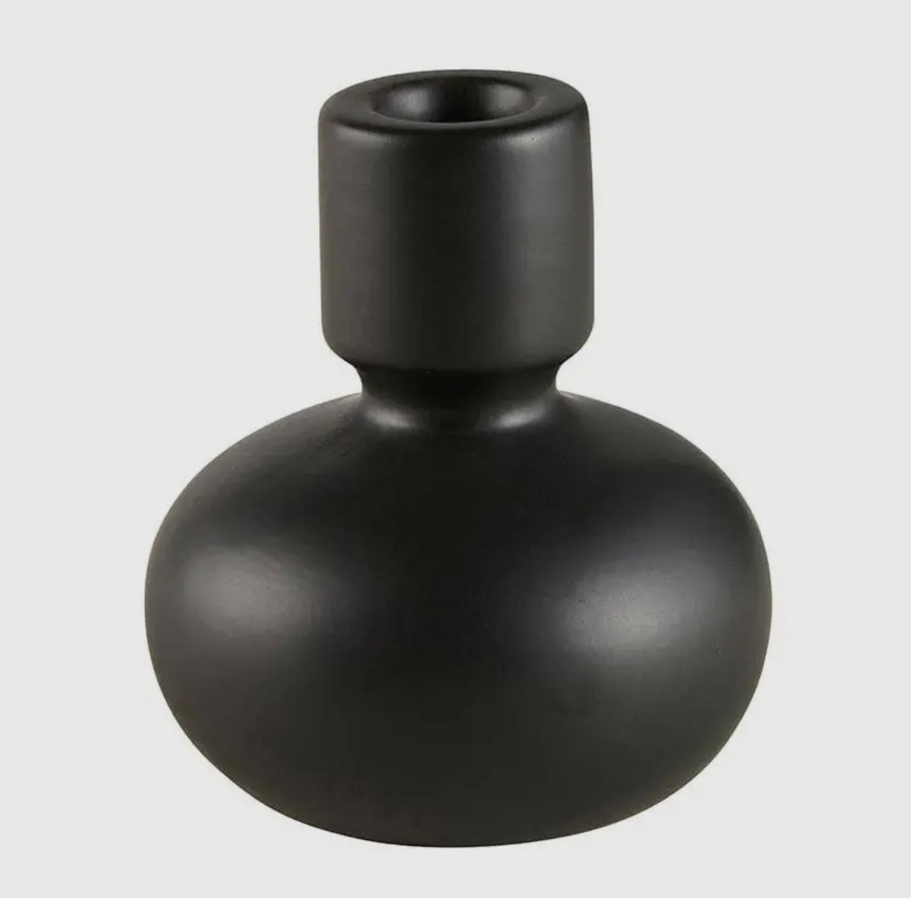 White and black ceramic vase and candle holder with a sleek, modern design, ideal for home decor.
