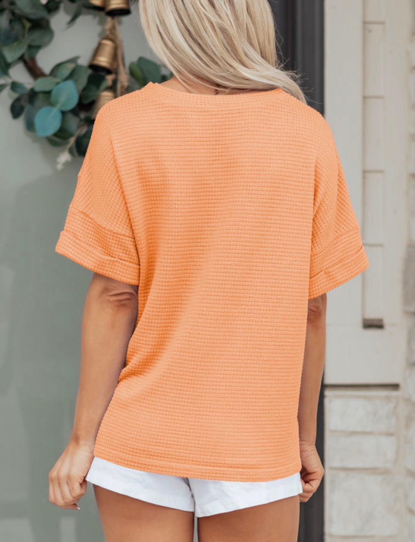 Orange waffle weave short sleeve V-neck top by Ivy's Gifts & Boutique, featuring a textured fabric and classic fit.