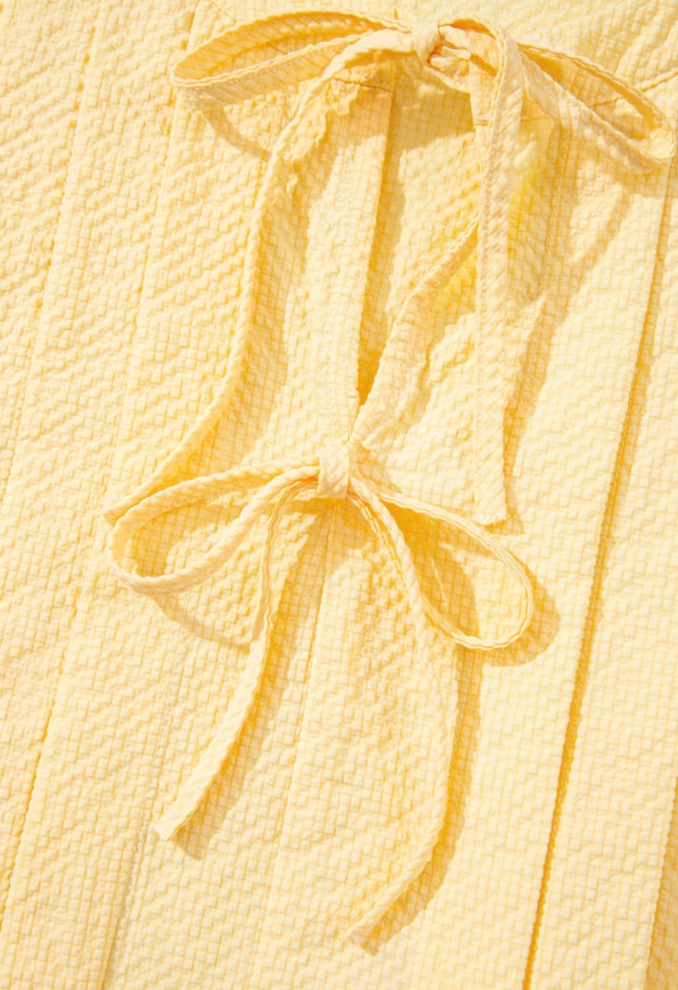 ML20 Yellow Sleeveless Blouse with Trendy Bow Closure And Pleats
