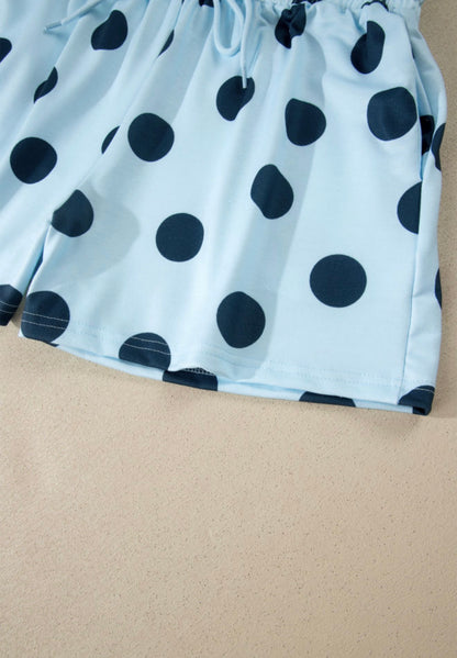 Light blue polka dot 2-piece short set for girls by Ivy's Gifts & Boutique, featuring a short-sleeve top and matching shorts.