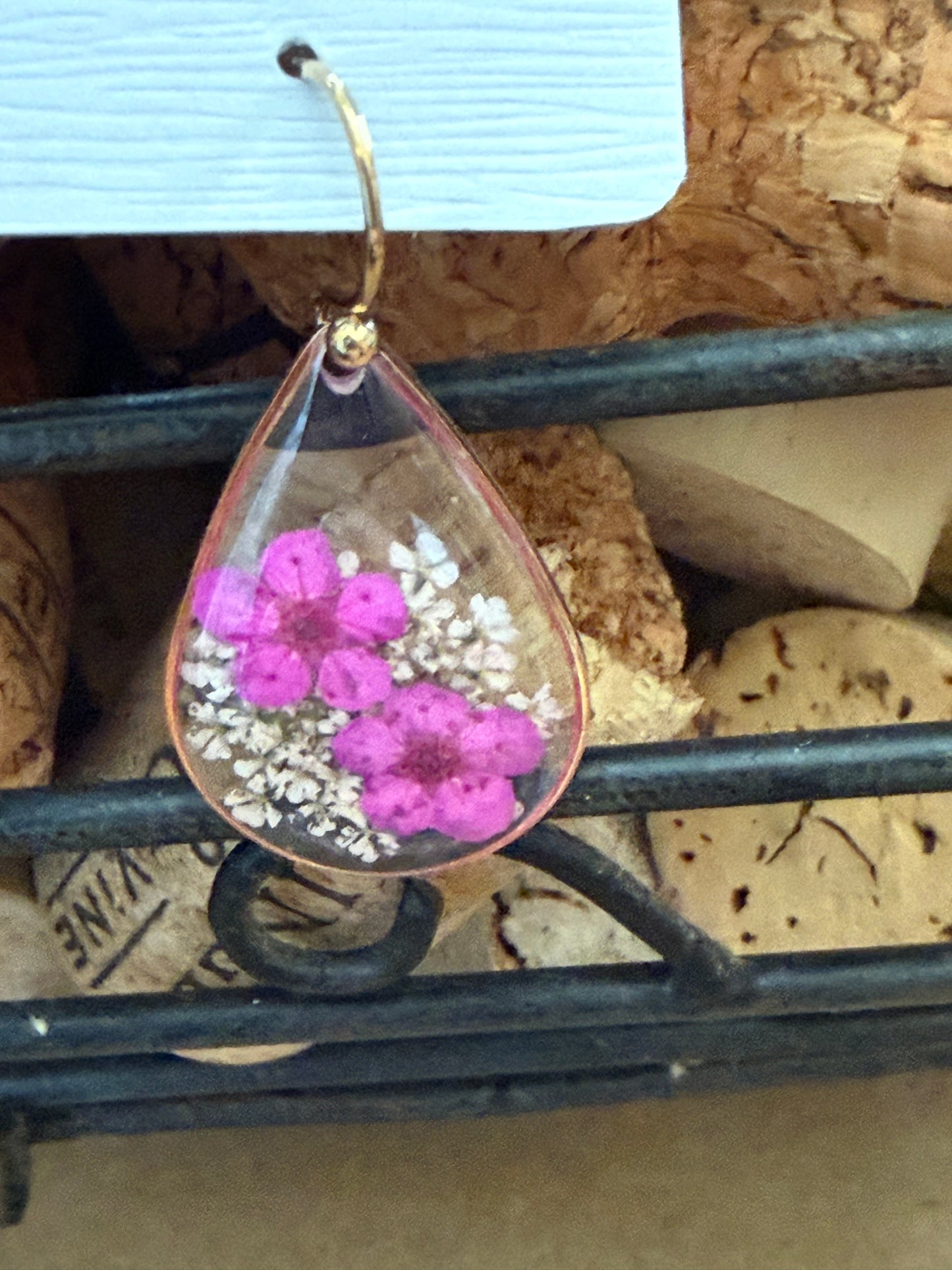 Dried flower earrings by Ivy's Gifts & Boutique featuring delicate flower charms hanging from silver hooks.
