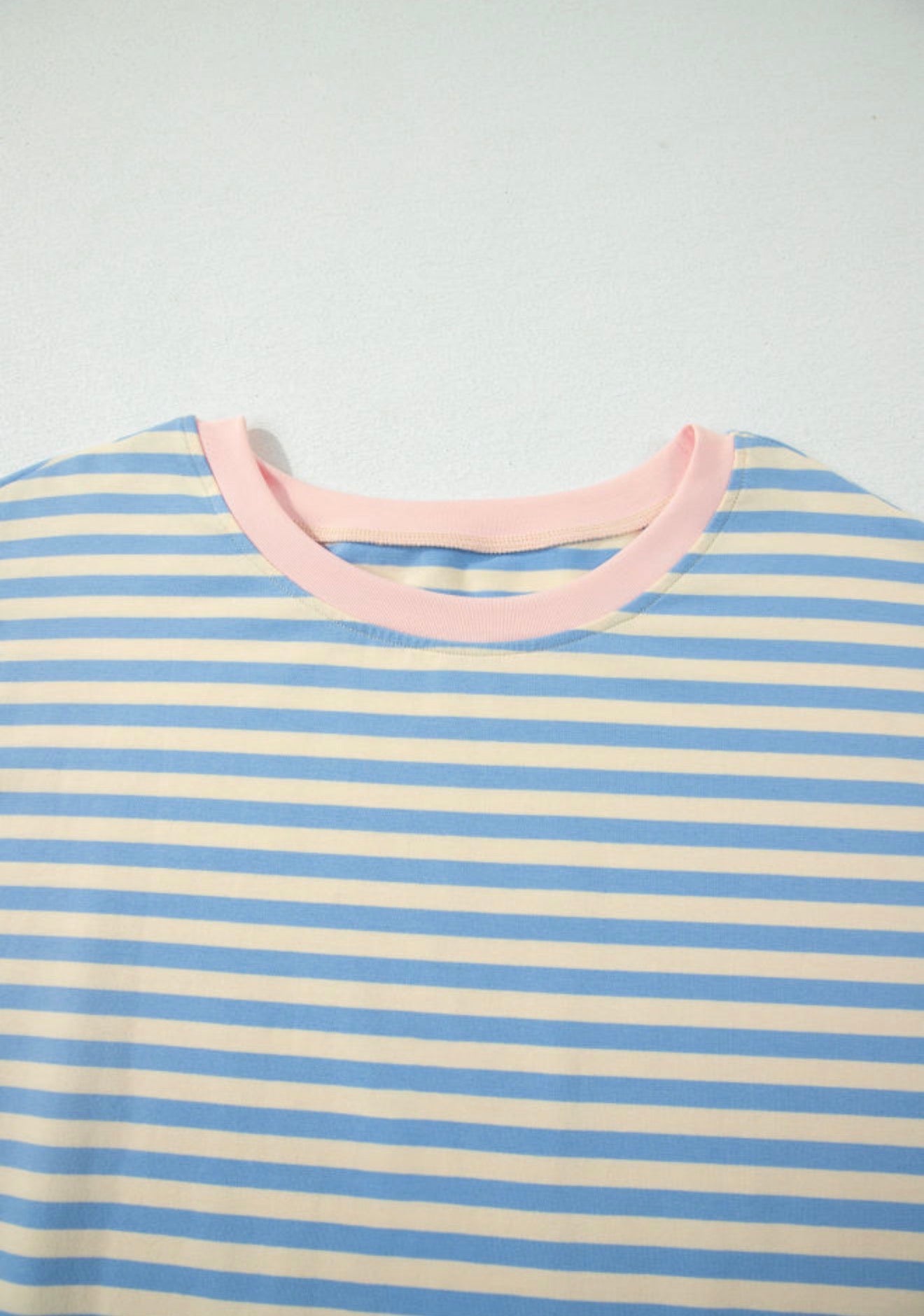 Sky blue drop shoulder stripe top with baby pink contrast trim around the neck, by Ivy's Gifts & Boutique.
