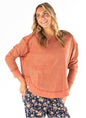 Rust-colored SSWW waffle weave cropped top with exposed seams, featuring a stylish, textured fabric and relaxed fit.