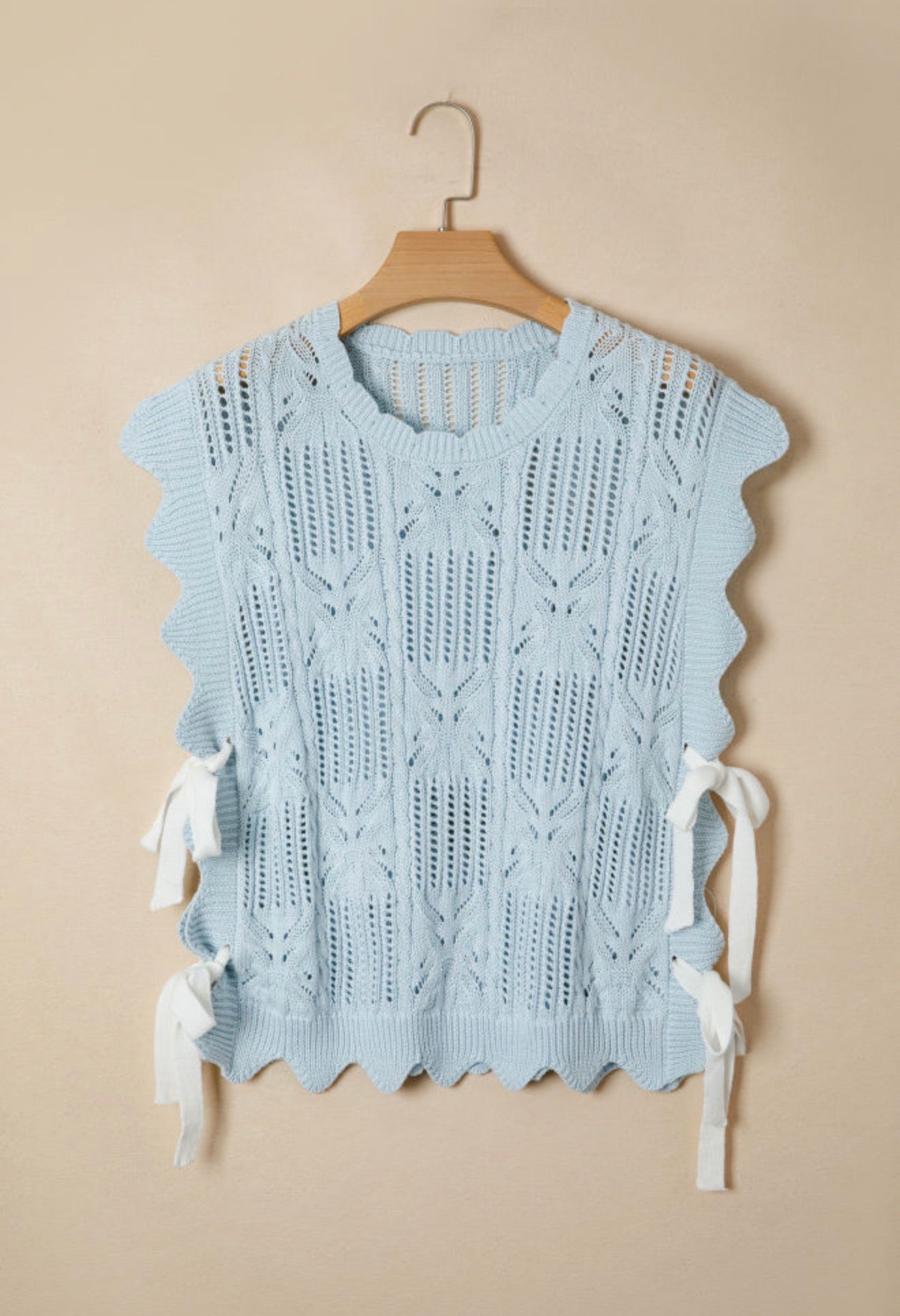 Light blue summer sweater from Ivy's Gifts & Boutique featuring side tie accents and a relaxed, stylish fit.