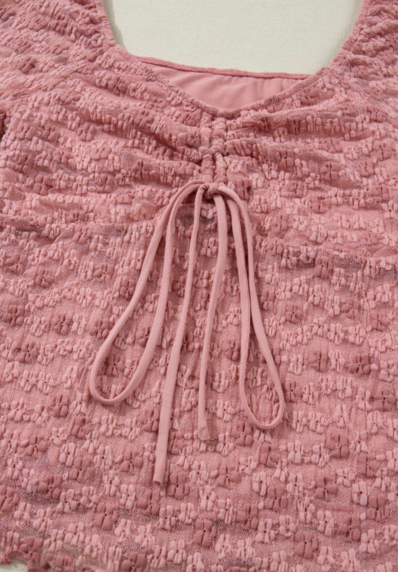 Pink floral lace top with flattering neckline, designed by Ivy's Gifts & Boutique, showcasing intricate lace details.