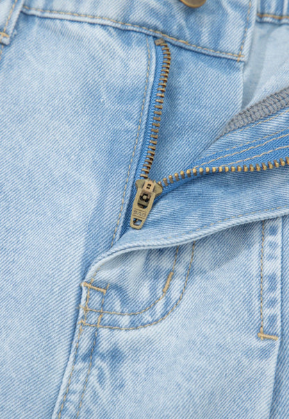 Light wash wide leg jeans by Ivy's Gifts & Boutique with frayed hems, side splits, and studded accents.