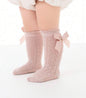 Cute baby knee socks from Ivy's Gifts & Boutique with bow detail, soft fabric, and colorful striped pattern for little girls.