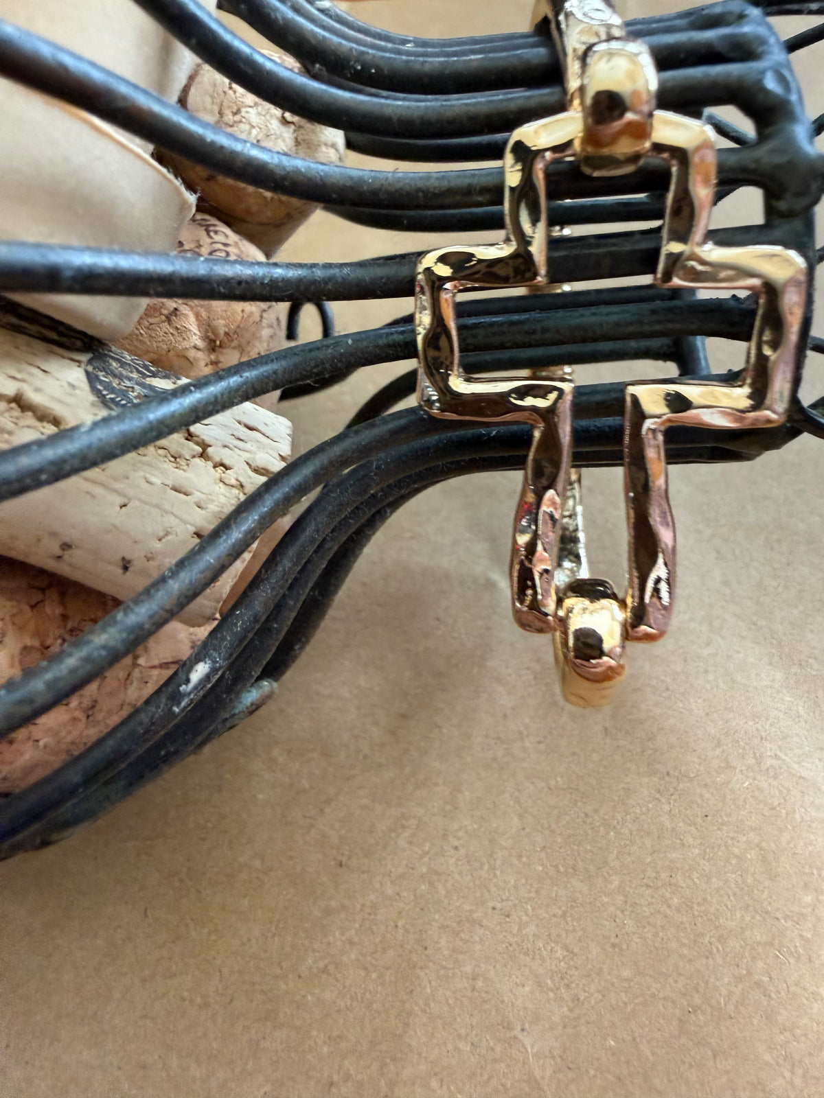 Gold J25 Cross bangle bracelet from Ivy's Gifts & Boutique featuring a flexible spring design for comfortable wear.