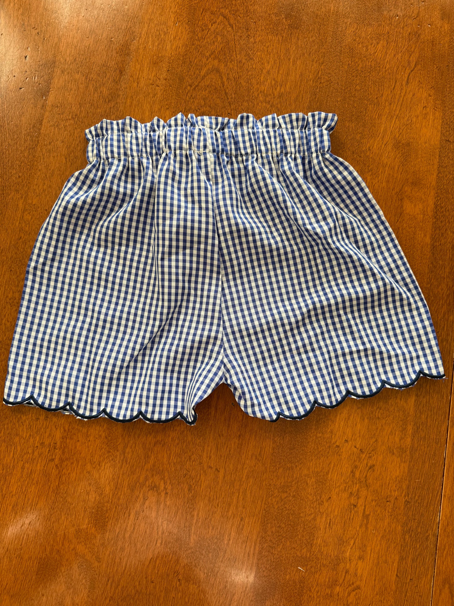 Navy gingham bow detail two-piece scallop hem short set for girls by Ivy's Gifts & Boutique, featuring a matching top and shorts.