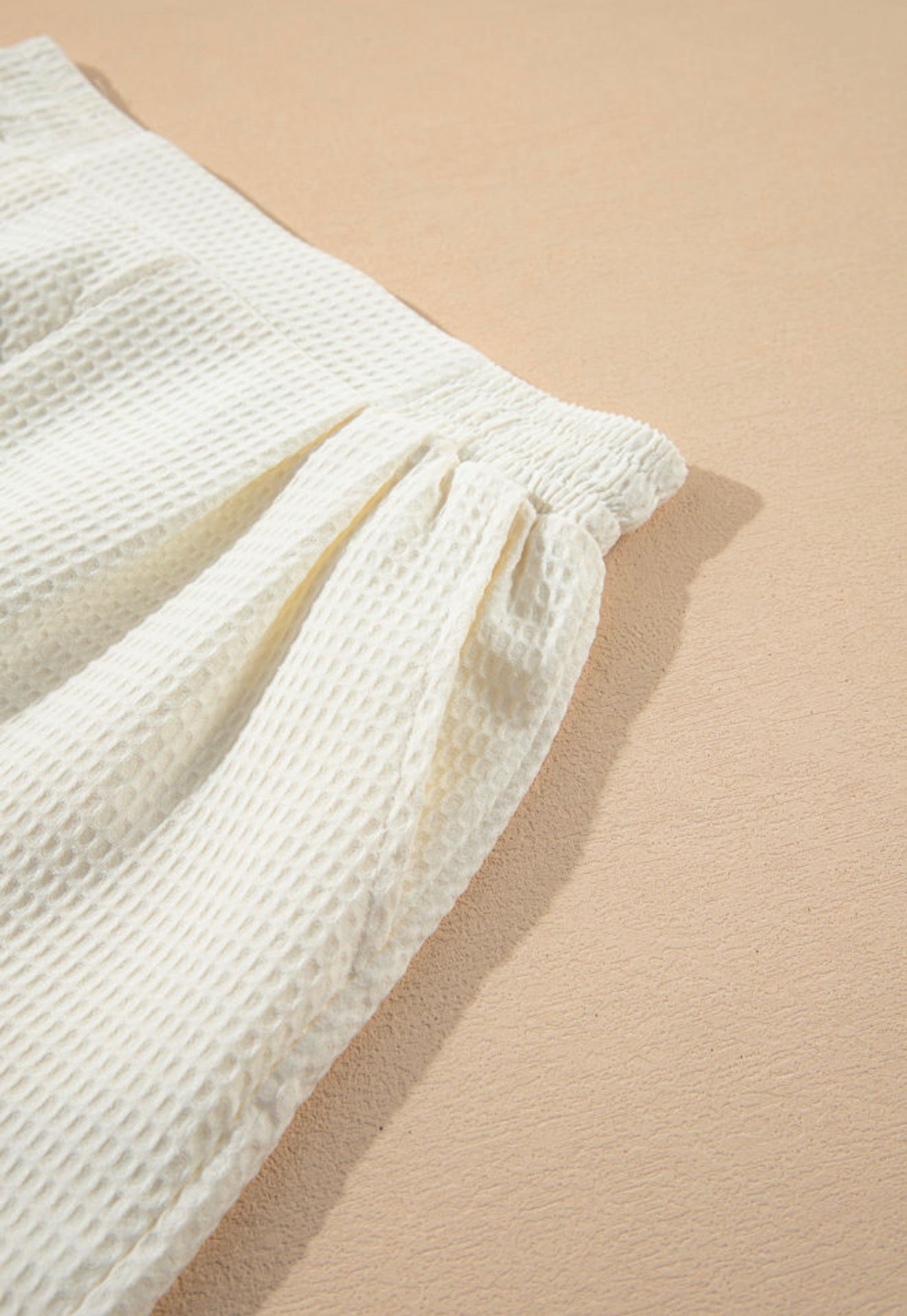 White waffle weave shorts with pockets and elastic waistband from Ivy's Gifts & Boutique, shown with a relaxed fit and casual style.