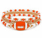 Stack of four TN58 orange and white beaded football bracelets by Ivy's Gifts & Boutique, featuring sporty, colorful bead designs.
