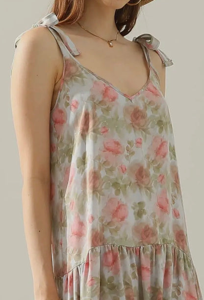 Floral maxi dress with shoulder straps from Ivy's Gifts & Boutique, featuring a tie detail and vibrant floral pattern.