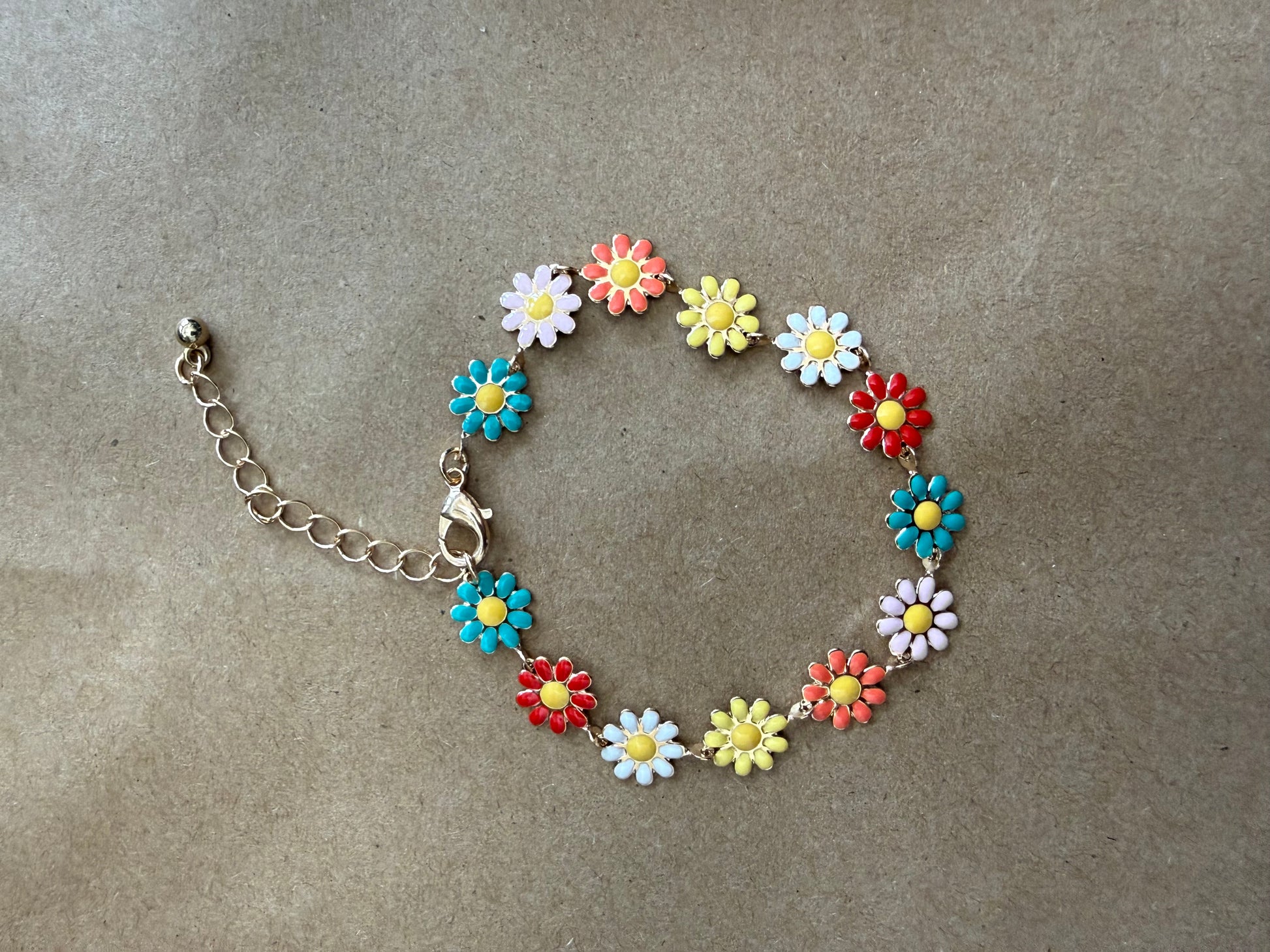 Daisy flower bracelet by Ivy's Gifts & Boutique featuring delicate white daisies and silver chain on a white background.