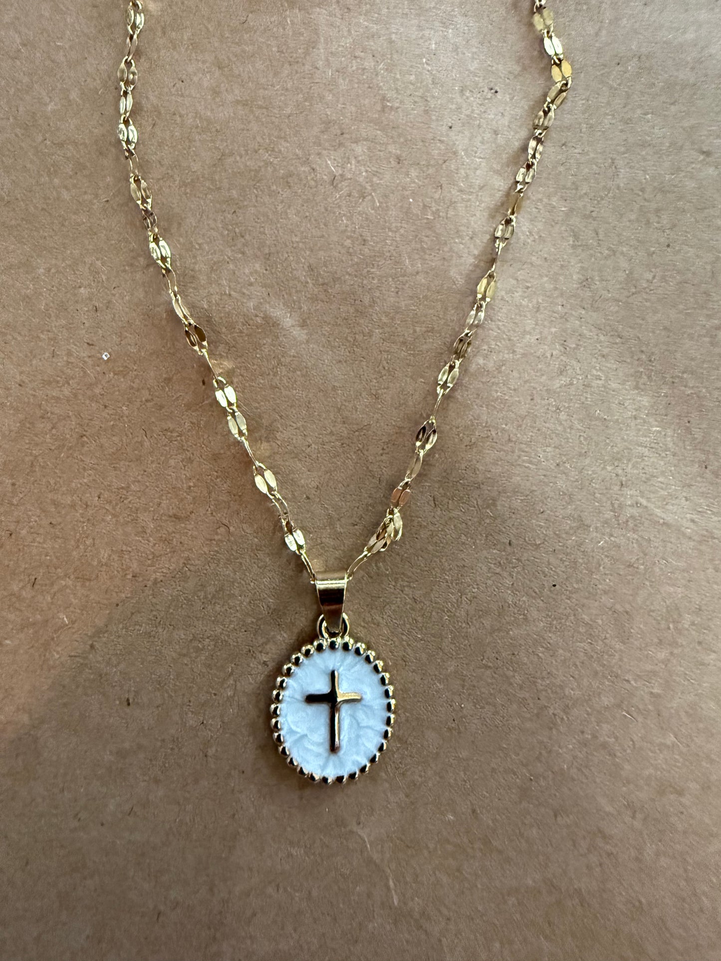 Enamel cross necklace with detailed design, hanging on a chain, crafted by Ivy's Gifts & Boutique.