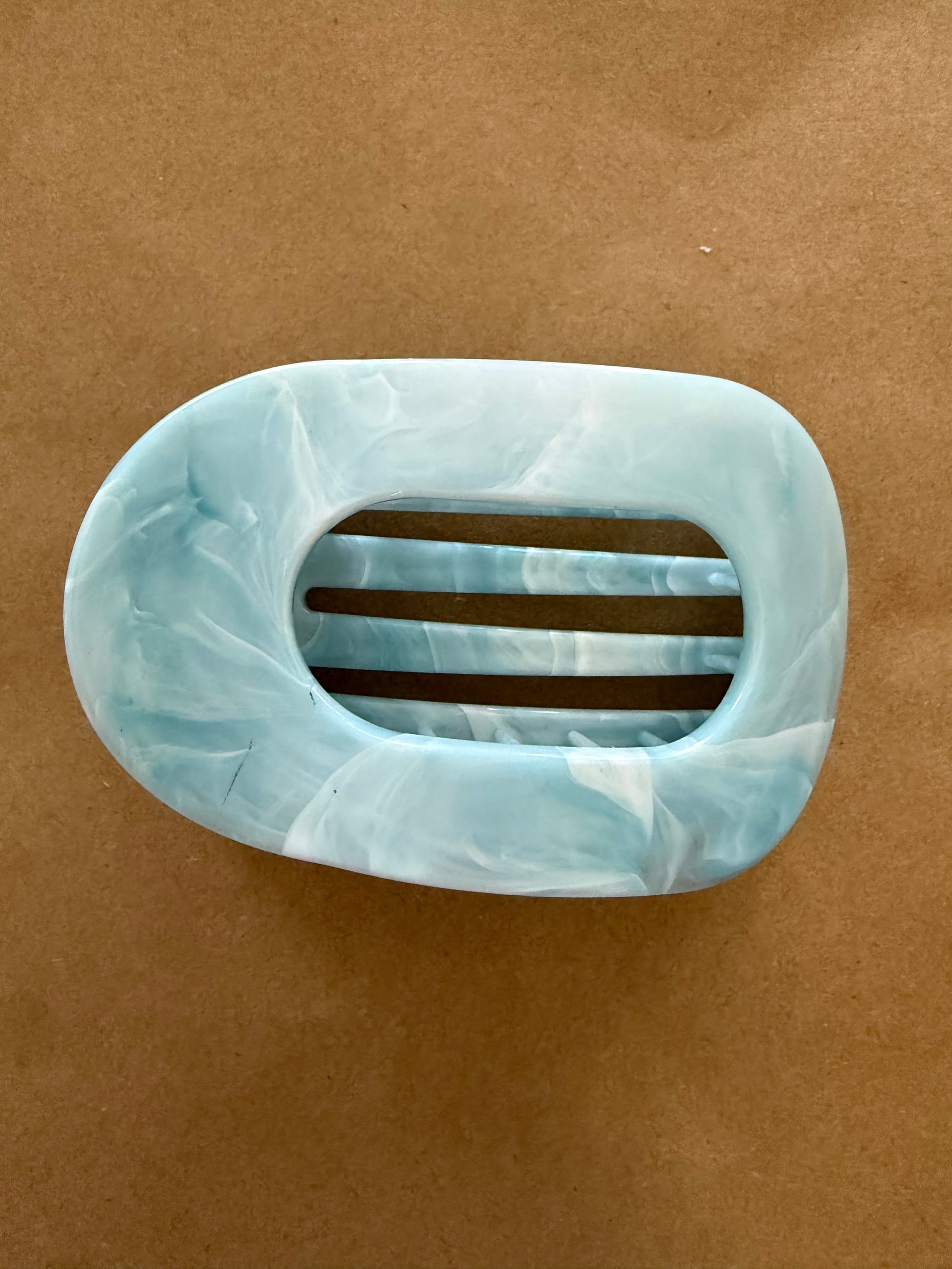 Marbled color flat claw clip by Ivy's Gifts & Boutique with smooth, wide design for secure hair styling.
