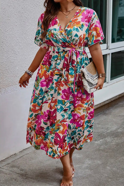 Floral printed dress by Ivy's Gifts & Boutique, featuring vibrant colors and a flowing silhouette.