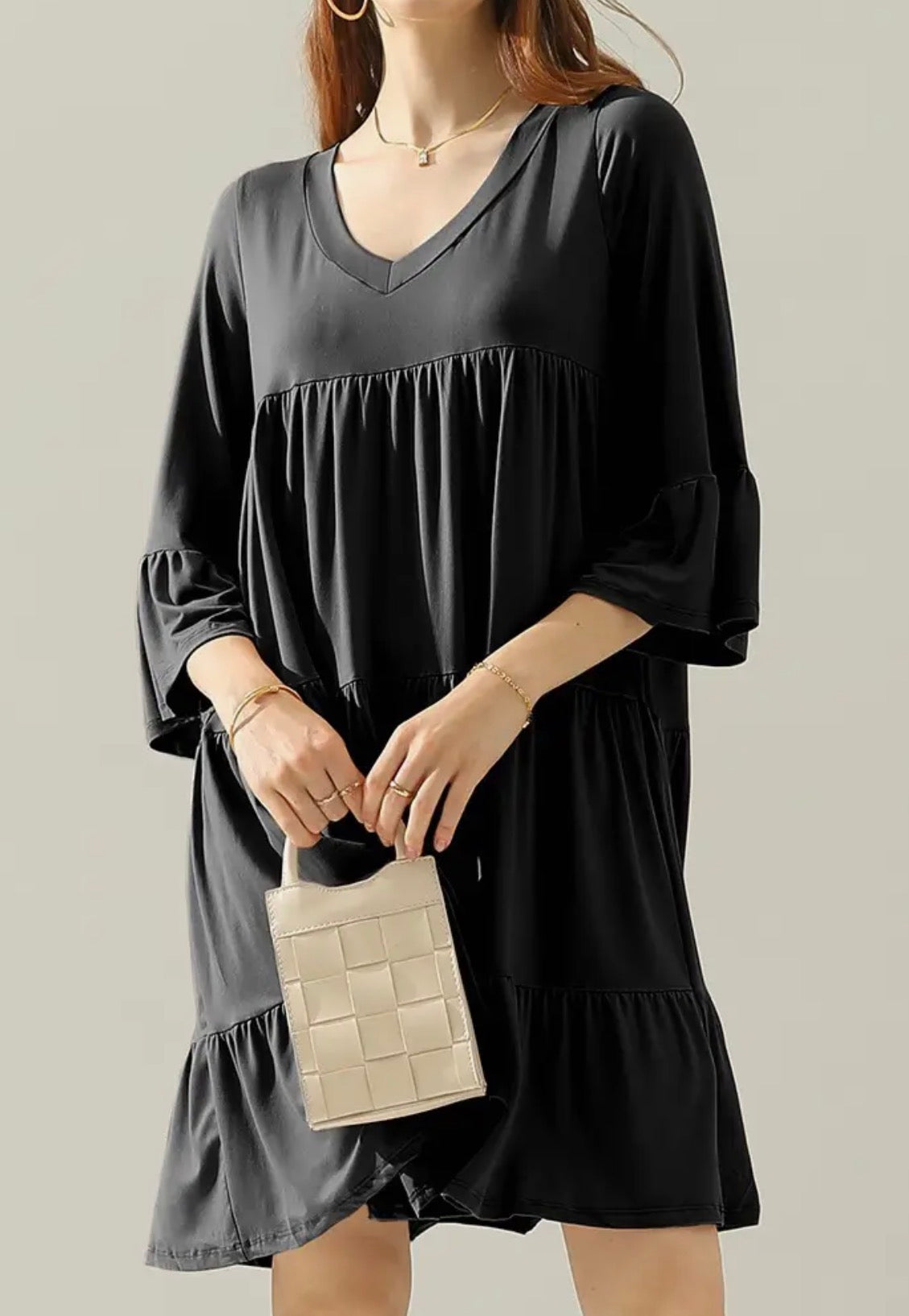 Black FR20 3-tier dress with 3/4 sleeves and ruffle hem by Ivy's Gifts & Boutique, shown on a hanger.
