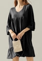 Black FR20 3-tier dress with 3/4 sleeves and ruffle hem by Ivy's Gifts & Boutique, shown on a hanger.