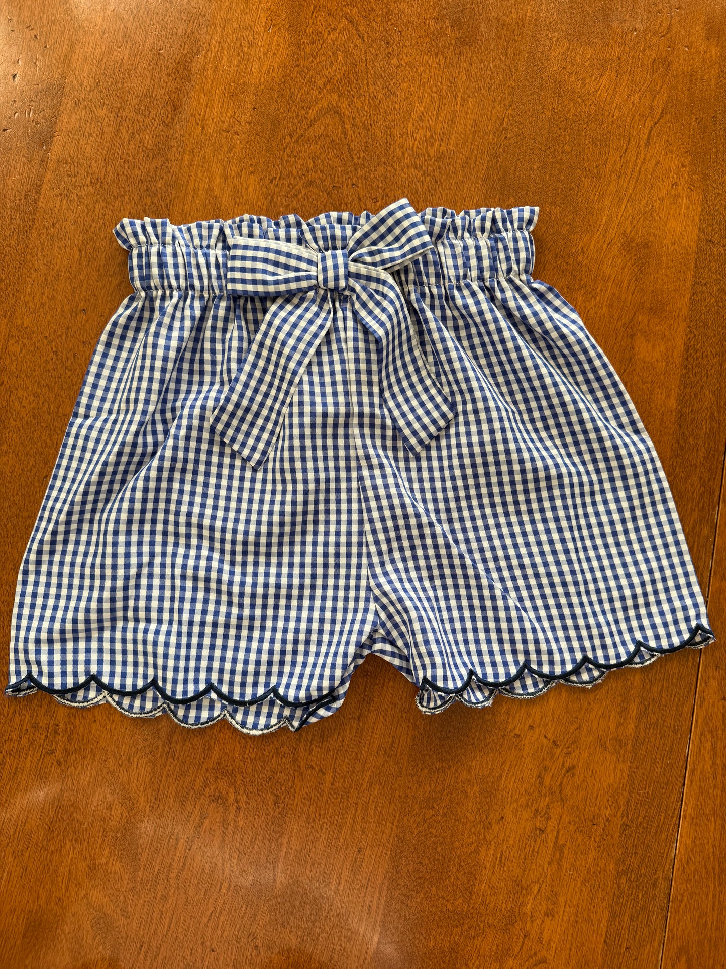 Navy gingham bow detail scalloped hem 2-piece short set for kids by Ivy's Gifts & Boutique, featuring a cute, coordinated design.