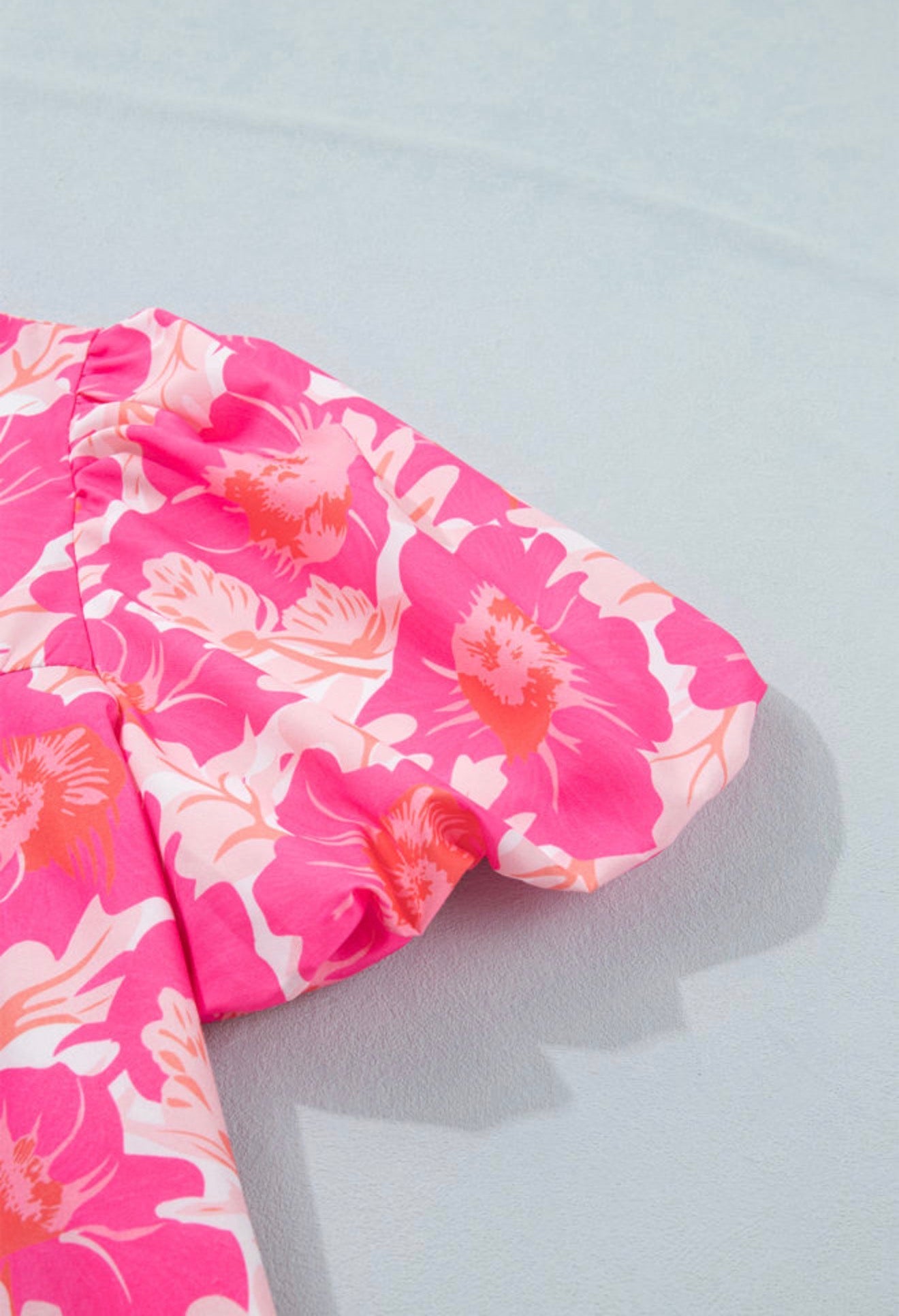 Pink and orange floral bubble sleeve summer top from Ivy's Gifts & Boutique, featuring a short style and vibrant floral pattern.