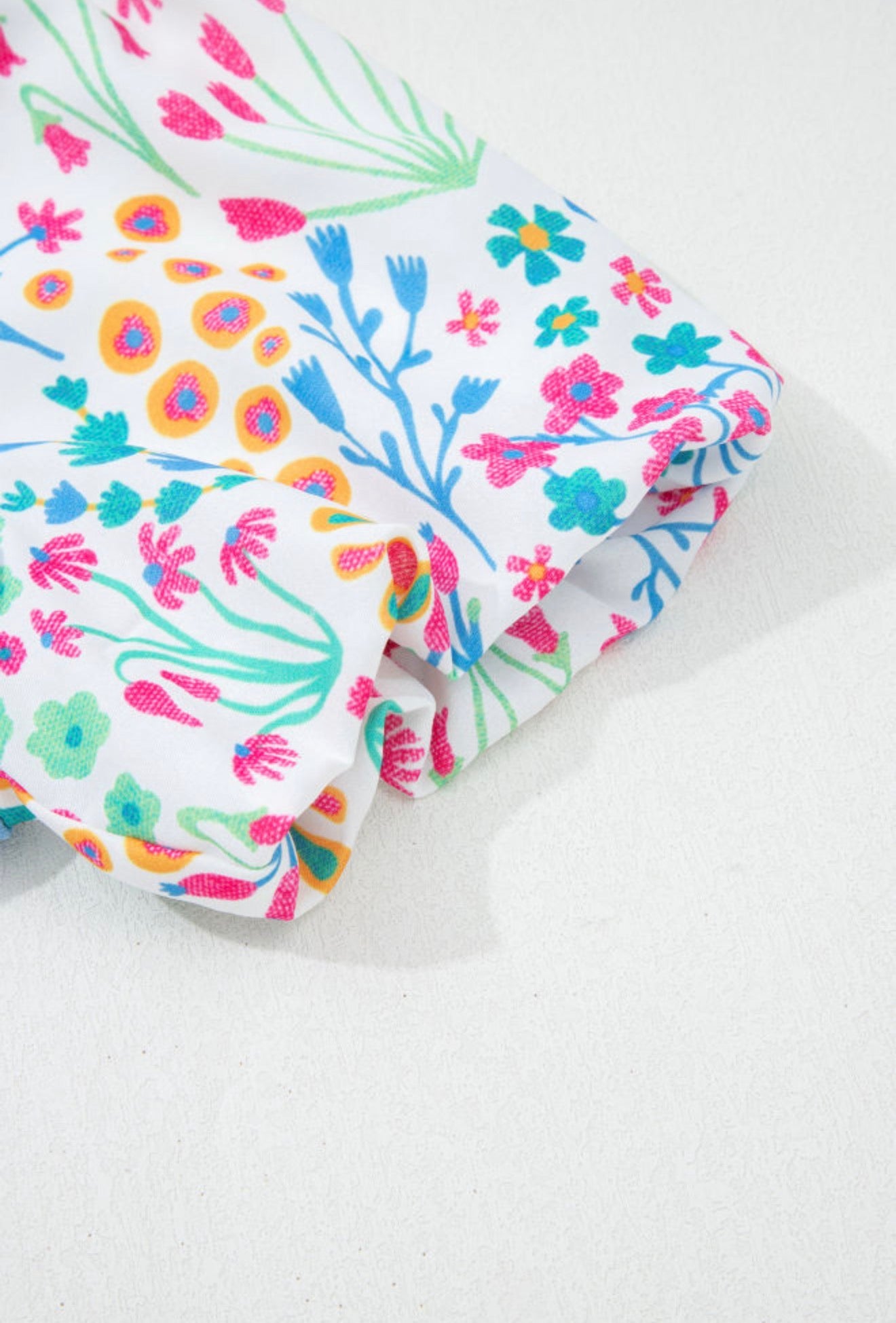 Light blue floral puff sleeve top from Ivy's Gifts & Boutique, featuring a stylish and feminine design.