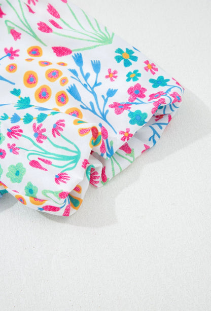 Light blue floral puff sleeve top from Ivy's Gifts & Boutique, featuring a stylish and feminine design.
