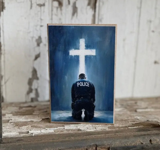 Police Officer Kneeling At The Foot Cross Of The Cross