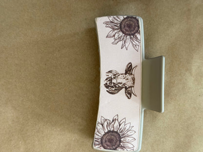Leatherette sunflower claw clip by Ivy's Gifts & Boutique, showcasing a decorative yellow sunflower design and strong hair grip.