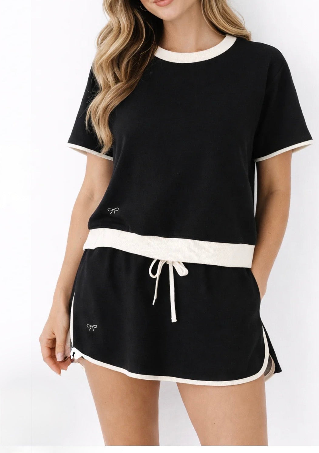 Black and ivory trimmed skort set for women, featuring a two-piece design from Ivy's Gifts & Boutique, shown laid flat.