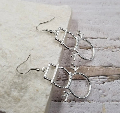 Silver snowman silhouette earrings with a 3D design, featuring festive holiday charm, ideal for winter and Christmas accessories.