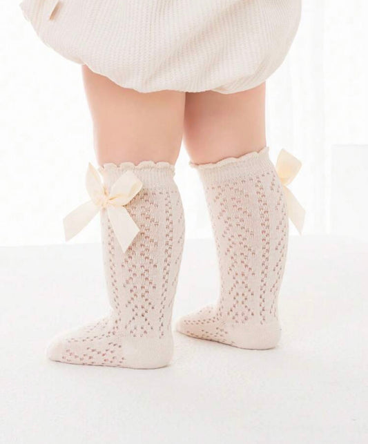 Baby knee socks with bow detail from Ivy's Gifts & Boutique, soft fabric with adorable bow accents for infants.