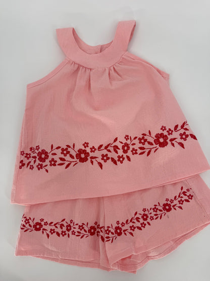 Pink crinkle fabric two-piece short set with red floral accents, by Ivy's Gifts & Boutique, featuring a stylish, casual summer look.