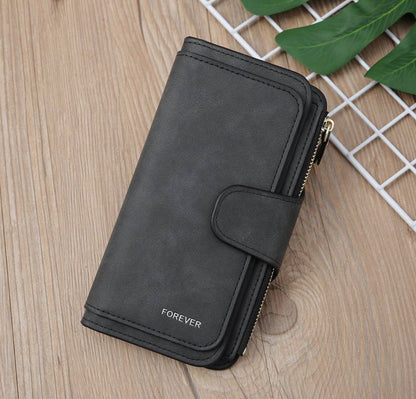Vegan leather women's wallet with zippered coin pouch and multiple card and ID storage pockets, by Ivy's Gifts & Boutique.