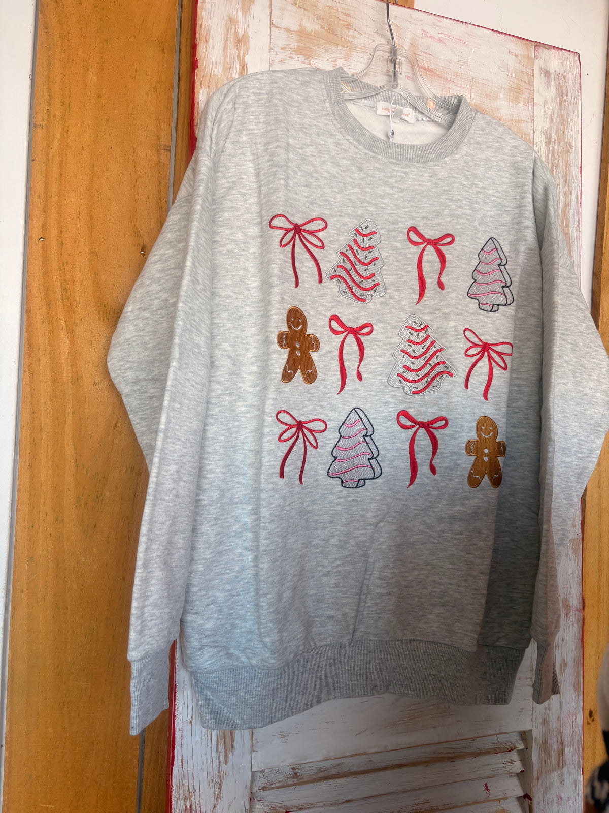 SSCC Long Sleeve Super Soft Holiday Sweatshirt with Christmas Tree Cake, Gingerbread, and Bow details